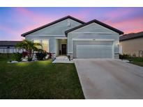 Charming single-Gathering home with a two-car garage, well-maintained lawn, and beautiful landscaping at 2232 Harris Hawk, Ruskin, FL 33570