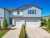 Charming two-story townhouse with attached garages and landscaped front yards at 2895 Deer Pine Trl, Land O Lakes, FL 34638