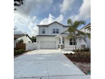Charming two-story home featuring a classic white exterior and a welcoming two-car garage at 5011 21St N Ave, St Petersburg, FL 33710