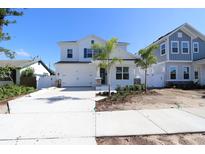 Charming two-story home featuring a well-manicured front yard, a wide driveway, and inviting curb appeal at 5011 21St N Ave, St Petersburg, FL 33710