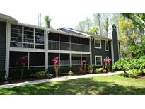 Charming condo featuring a screened lanai, upper balcony, manicured landscaping and neutral paint scheme at 2101 Fox Chase Blvd # 102, Palm Harbor, FL 34683