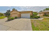 Charming single-story home with a well-manicured lawn and a two-car garage at 2112 Acadia Greens Dr # 62, Sun City Center, FL 33573