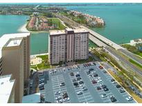 Striking aerial view highlighting condo with parking, serene waterfront views, and easy bridge access at 5220 Brittany S Dr # 210, St Petersburg, FL 33715