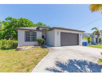 Charming single-story home with well-maintained lawn, gray trim, and a two-car garage at 6426 31St S St, St Petersburg, FL 33712