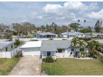Charming single-story home with a two-car garage, well-maintained lawn, and mature landscaping at 16315 2Nd E St, Redington Beach, FL 33708