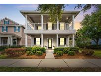 Charming two-story home featuring a covered porch with white columns and well-manicured landscaping at 16906 Dorman Rd, Lithia, FL 33547