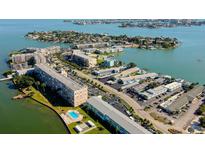 Gorgeous aerial view showcases waterfront living and building amenities including the swimming pool at 1847 Shore Drive South # 308, South Pasadena, FL 33707