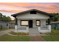 Charming home featuring white siding, black trim, covered porch, and freshly landscaped front yard at 2920 E 20Th Ave, Tampa, FL 33605