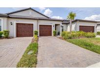 Charming home showcasing a neatly paved driveway leading to its two-car garage and freshly manicured lawn at 31408 Cabana Rye Ave, San Antonio, FL 33576