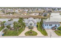 Aerial view showcases a waterfront property with extensive canals and waterway access for boating and recreation at 3432 Bluefish Dr, Hernando Beach, FL 34607