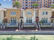Waterfront townhomes feature private patios, lush landscaping, and stunning architectural design at 525 Mandalay Ave # 33, Clearwater Beach, FL 33767