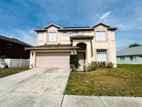 Two-story home showcasing a two-car garage and well-maintained front lawn at 12814 Longcrest Dr, Riverview, FL 33579