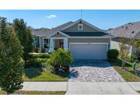 Charming single-story home with a two-car garage, well-manicured landscaping, and a brick-paved driveway at 13917 Kingfisher Glen Dr, Lithia, FL 33547