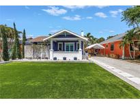 Charming blue home with a well-manicured lawn and inviting front porch at 145 19Th Se Ave, St Petersburg, FL 33705