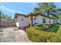 Inviting front entrance showcasing a bright exterior, neat landscaping, and a charming covered porch at 1726 25Th S Ave, St Petersburg, FL 33712