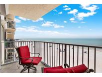 Balcony featuring red chairs and a table overlooking the beach at 18650 Gulf Blvd # 303, Indian Shores, FL 33785