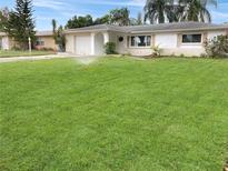 Well-maintained lawn and landscaping surrounds this single story home featuring a one car garage at 2127 Scotland Dr, Clearwater, FL 33763