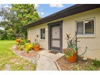 Inviting front entrance with lovely landscaping and potted plants enhancing the curb appeal of this cozy home at 2934 Lichen Ln # A, Clearwater, FL 33760