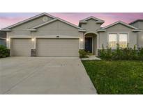 Charming one-story home with a two car garage, well-maintained lawn, and neutral stucco exterior at 6674 Cobble Bliss St, Zephyrhills, FL 33541
