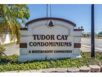 Entrance sign to Tudor Cay Condominiums, a waterfront community with manicured landscaping at 9105 W Hillsborough Ave # I102, Tampa, FL 33615