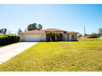 Charming single-story home featuring a spacious front yard and an attached two-car garage at 10400 Golden Ave, Weeki Wachee, FL 34613