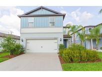 Charming two-story home features a well-manicured lawn and two car garage at 20925 Monza Loop, Land O Lakes, FL 34638