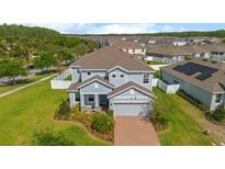 Beautiful two-story home with a well-manicured lawn and a brick driveway, adding to its curb appeal at 2121 Secret Cv, Odessa, FL 33556
