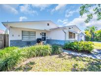 Charming single-story home featuring a well-kept lawn and quaint curb appeal under a bright sky at 753 Almeda N St, St Petersburg, FL 33702