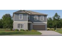 Two story home with grey siding, attached two car garage, landscaped yard and concrete driveway at 8536 Bella Mar Trl, Parrish, FL 34219