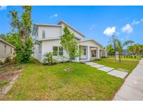 Modern two-story home with a bright white exterior, manicured lawn, and a welcoming front porch at 1030 11Th S Ave, St Petersburg, FL 33705