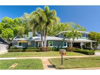 Charming home with mature landscaping and a spacious covered carport nestled among mature trees at 126 Orangewood Dr, Dunedin, FL 34698