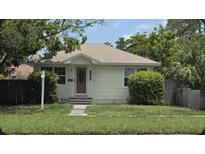 Charming single-story home featuring mature trees, a well-maintained lawn, and a welcoming front entrance at 2585 9Th N Ave, St Petersburg, FL 33713
