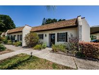 Charming villa with a well-maintained yard and classic architectural details, creating a welcoming curb appeal at 3143 Mission Grove Dr, Palm Harbor, FL 34684