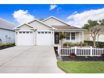 Charming single-story home with a two-car garage, well-manicured lawn, and inviting front porch at 37438 Picketts Mill Ave, Zephyrhills, FL 33542