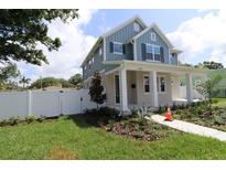 Charming two-story home with a covered porch and landscaped front yard at 5235 9Th N Ave, St Petersburg, FL 33710