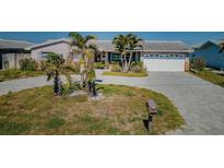 Charming single Gathering home with a two car garage, mature palm trees, and beautiful paved driveway at 5434 Oakhurst Dr, Seminole, FL 33772