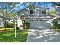 Charming two-story home featuring a well-manicured lawn and an attached two-car garage at 11831 Lancashire Dr, Tampa, FL 33626