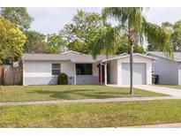 Charming single-story home with fresh exterior paint, manicured lawn and mature landscaping at 1254 8Th Ne Ave, Largo, FL 33770