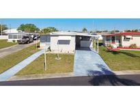 Charming single-story home with a covered carport and well-maintained landscaping at 13225 101St St # 107, Largo, FL 33773