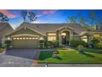 Charming one-story home with a well-manicured lawn, tasteful landscaping, and an attached two car garage at 28402 Openfield Loop, Wesley Chapel, FL 33543