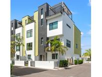 Striking modern townhomes feature a sleek design with black accents, white walls, and a private rooftop terrace at 907 Arlington N Ave, St Petersburg, FL 33705