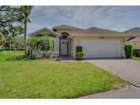 Inviting single-Gathering home with a well-manicured lawn and attached two-car garage at 1129 Haley Ln, Dunedin, FL 34698