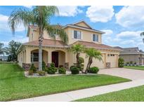 Charming two-story home boasts a well-manicured lawn, complemented by lush landscaping and a three-car garage at 19123 Sunset Bay Dr, Land O Lakes, FL 34638