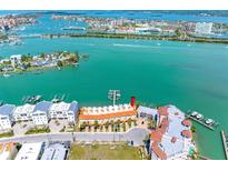 Stunning aerial view of waterfront condo complex with boat docks and beautiful turquoise water views at 200 Brightwater Dr # 10, Clearwater Beach, FL 33767