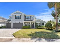 Charming two-story home with manicured lawn, three-car garage and beautifully designed façade at 2316 S Thixton Ct, Tampa, FL 33629