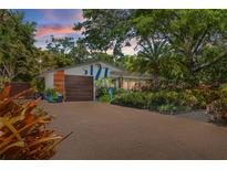 Charming single-story home with lush landscaping, a statement garage door and ample parking at 5127 29Th S Ave, Gulfport, FL 33707