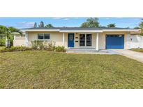 Charming single-story home with blue door and garage and freshly cut lawn at 783 41St Ne Ave, St Petersburg, FL 33703