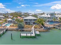 Beautiful waterfront home featuring private dock with panoramic water views on a sunny day at 931 Inlet Cir, Venice, FL 34285