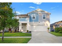 Charming two-story home featuring a well-manicured lawn and attached two-car garage at 13110 Shumard Way, Riverview, FL 33579