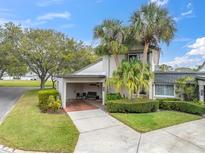 Charming two-story home with well-manicured landscaping and inviting carport area at 2647 Barksdale Ct, Clearwater, FL 33761